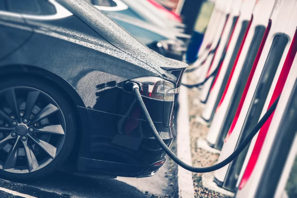 Close-up of line of cars at electric vehicle charging station